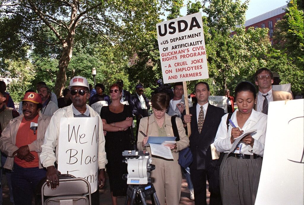 Black farmers protest at Lafayette Park across from the White House in Washington, D.C. on September 22, 1997. Protesters alleged the U.S. Department of Agriculture (USDA) denied black farmers equal access to farm loans and assistance based on their race. North Carolina farmer Timothy Pigford and 400 other black farmers filed the Pigford v. Glickman (Pigford I) class-action lawsuit against USDA in 1997. The USDA settled Pigford I in 1999. USDA photo by Anson Eaglin..